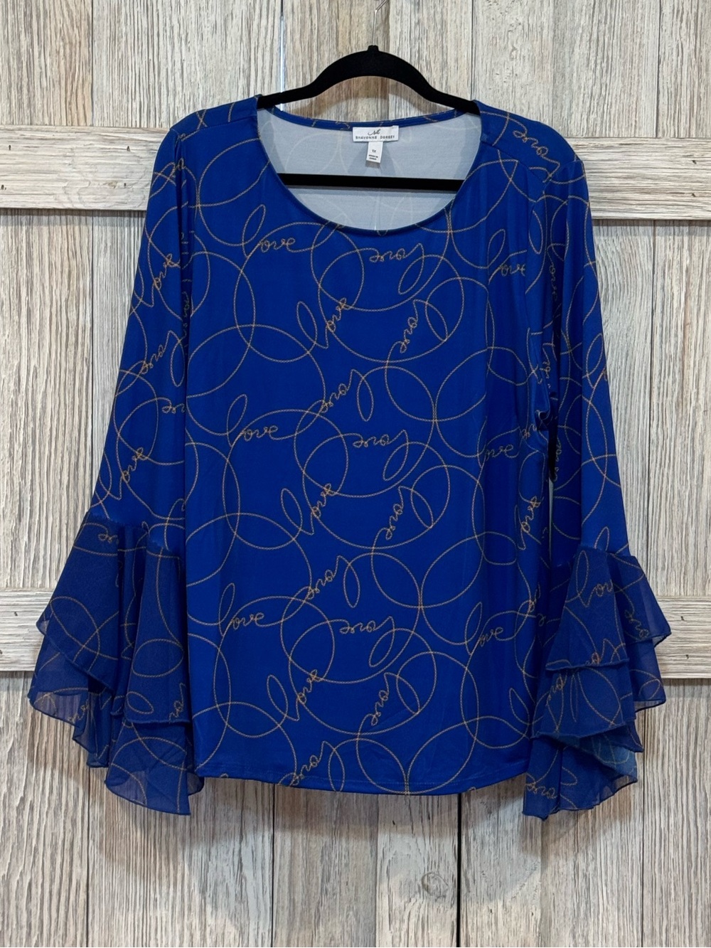 Shavonne Dorsey Royal Blue Ruffle SleeveTop w/Love written in Gold all over.